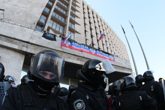 Pro-Russian supporters deploy a Russian flag and the flag of the so-called Donetsk Republica as they storm the regional administration building in the eastern Ukrainian city of Donetsk on April 6, 2014 (AFP Photo / Alexandr Khudoteply)