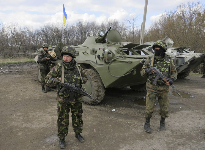 Ukrainian soldiers are seen near armored personnel carriers at a checkpoint near the town of Izium in Eastern Ukraine, April 15, 2014. (Reuters / Dmitry Madorsky)