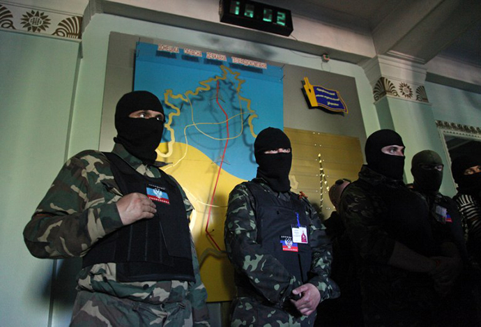 Masked activists stand guard a regional television station in the eastern Ukrainian city of Donetsk, on April 27, 2014. (AFP Photo / Anatoliy Stepanov)