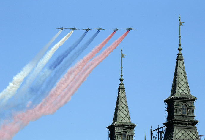 Russian military aircraft trail smoke in the colours of the Russian tricolor above the Victory Day Parade in Moscow's Red Square May 9, 2014. (Reuters)