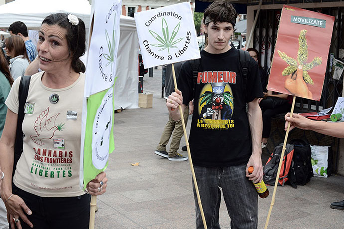 People hold signs reading ''Coordination hemp and freedoms'' during a protest to call for the legalization of marijuana on May 10, 2014 in Toulouse, southern France. (AFP Photo / Remy Gabalda)