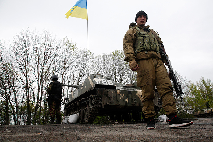 Ukrainian soldiers stand guard in front of armoured personnel carriers at a check point near the village of Malinivka, southeast of Slavyansk, in eastern Ukraine April 29, 2014 (Reuters)