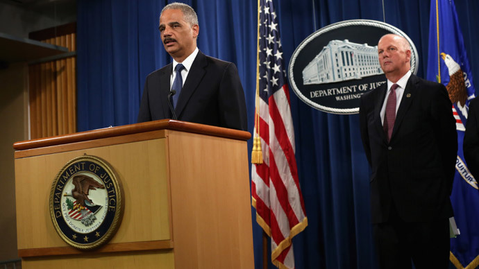 U.S. Attorney General Eric Holder (L) speaks as he announces indictments against Chinese military hackers on cyber-espionage as U.S. Attorney for Western District of Pennsylvania David Hickton (R) listens May 19, 2014 at the Department of Justice in Washington, DC.(AFP Photo / Alex Wong)