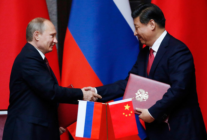 Russia's President Vladimir Putin (L) and China's President Xi Jinping shake hands after signing an agreement during a bilateral meeting at the Xijiao State Guesthouse ahead of the fourth Conference on Interaction and Confidence Building Measures in Asia (CICA) summit, in Shanghai May 20, 2014.(Reuters / Carlos Barria)