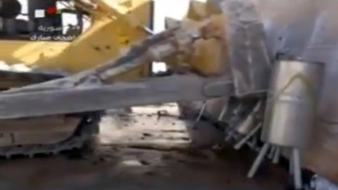 Mechanical digger from the Organisation for the Prohibition of Chemical Weapons (OPCW) at work at an undisclosed location in Syria.(AFP Photo / Syrian Television)