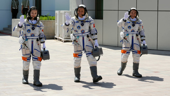 Chinese astronauts (from L to R) Wang Yaping, Nie Haisheng and Zhang Xiaoguang wave before leaving for the Shenzhou-10 manned spacecraft mission at Jiuquan satellite launch center in Jiuquan, Gansu province June 11, 2013.(Reuters / Stringer)