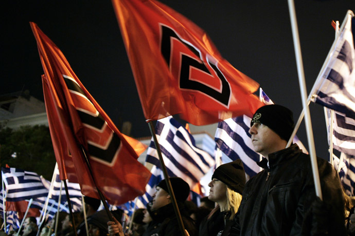 Member of the far right Golden Dawn party hold flags as they take part in a rally in Athens on February 1, 2014. (AFP Photo/Louisa Gouliamaki)
