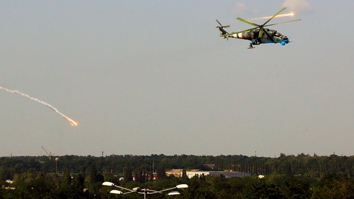 A Ukrainian helicopter Mi-24 gunship fires decoy flares over a residential area moments after attacking Donetsk international airport May 26, 2014. (Reuters / Yannis Behrakis)