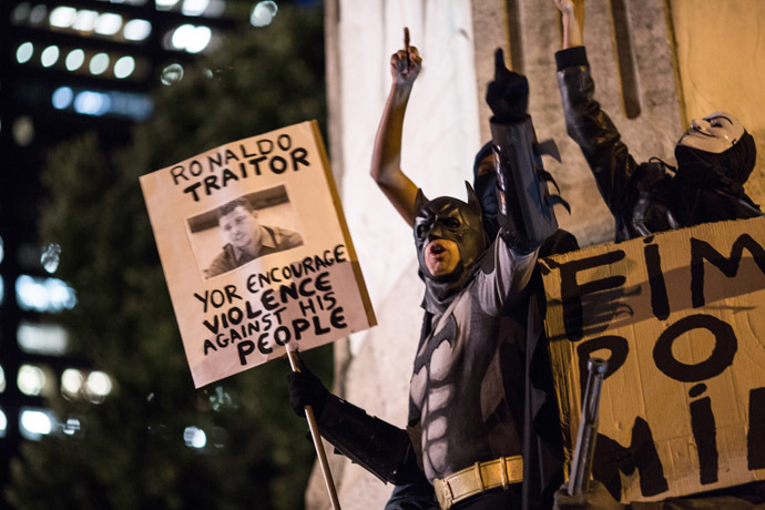 A man fancy-dressed as American comic hero Batman shouts slogans during a protest by anarchist group Black Bloc against the FIFA World Cup in Rio de Janeiro, Brazil, on May 30, 2014 (AFP Photo/YASUYOSHI CHIBA)