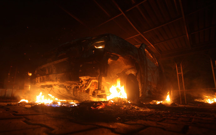 A burning car is seen at the U.S. Consulate in Benghazi during a protest by an armed group said to have been protesting a film being produced in the United States September 11, 2012.(Reuters / Esam Al-Fetori )