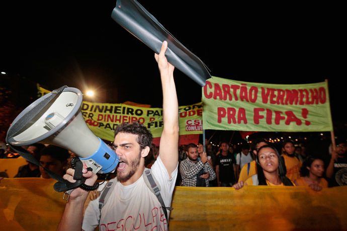 A man shouts through a megaphone during a protest against the money spent on preparations of the upcoming World Cup, in Brasilia May 30, 2014.(Reuters / Joedson Alves)