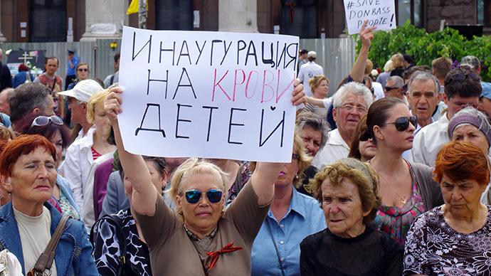 A woman holds a sign reading "Inauguration by the blood of children" during a rally held by pro-Russian activists marking International Day for Protection of Children in the southern Ukrainian city of Odessa on June 1, 2014. (AFP Photo / Alexey Kravtsov)