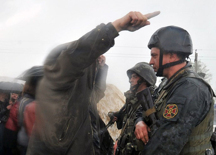 Ukrainian soldiers listen to anti-government protestors blocking the Kramatorsk to Slavyansk road to prevent the Ukrainian National Guard troops from advancing on May 2, 2014.
