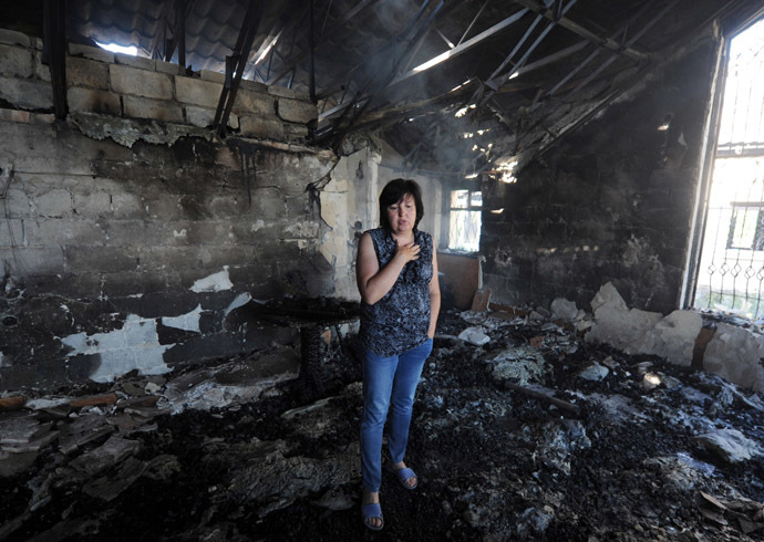 A woman stands in a cafe burnt during a night combat between Ukrainian and anti-government forces in the village of Semenovka, near the eastern Ukrainian city of Slavyansk, on May 22, 2014. (AFP Photo)
