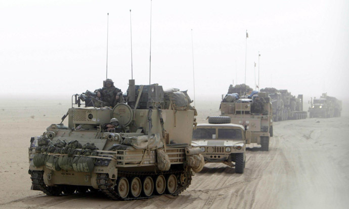 U.S. Army soldiers in heavy armour vehicles cross the border into Iraq from Kuwait early March 21, 2003. (Reuters/Kai Pfaffenbach)