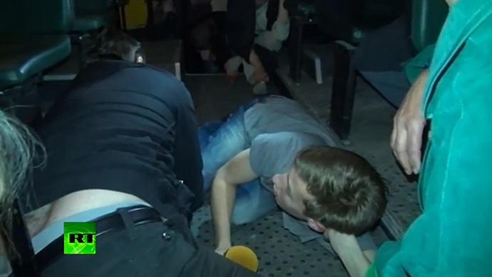 People lying on the floor of the bus (screenshot from RT video)
