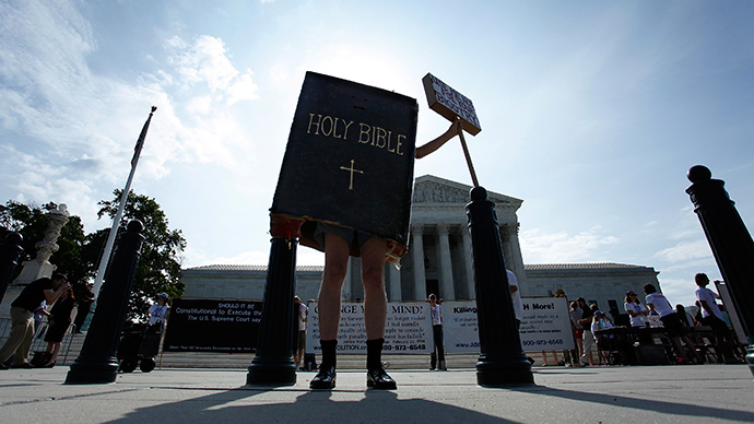 A protester dressed as a copy of the Bible joins groups demonstrating outside the U.S. Supreme Court in Washington June 30, 2014 (Reuters / Jonathan Ernst)