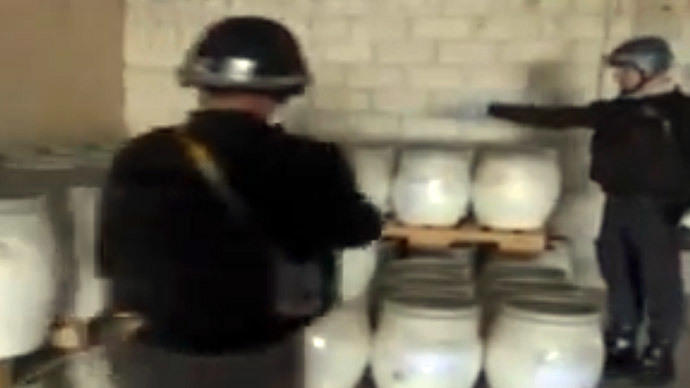 An inspectors from the Organisation for the Prohibition of Chemical Weapons (OPCW) at work at an undisclosed location in Syria. Chemical inspectors have checked 14 out of more than 20 sites in Syria, the world's chemical weapons watchdog said October 18, 2013.(AFP Photo / Syrian Television)
