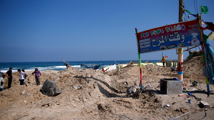 Palestinians search for bodies at a beach cafe hit the previous night by an Israeli air strike while people were watching the World Cup semi-final football match, on July 10, 2014 in the southern Gaza Strip city of Khan Yunis. (AFP Photo / Thomas Coex)