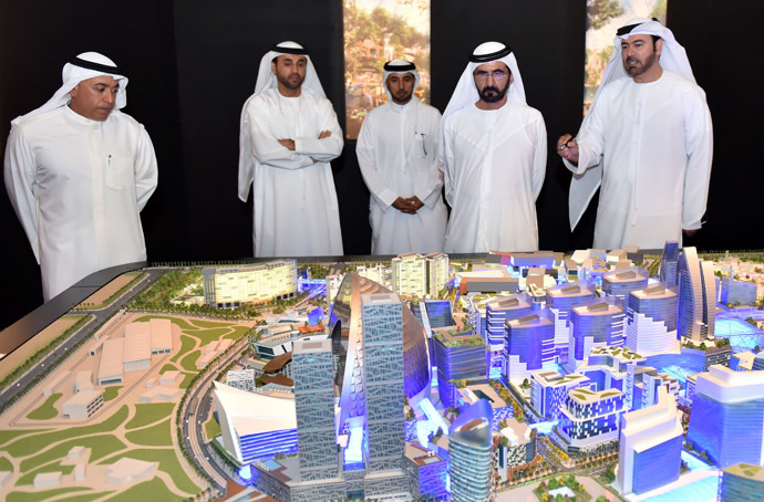 A handout picture made available on July 6, 2014 by the press office of Sheikh Mohammed Bin Rashid al-Maktoum, ruler of Dubai, shows him (2ndR) looking at the mock-up of the "Mall of the World" project during its presentation in Dubai. (AFP Photo/Sheikh Mohammed Bin Rashid)