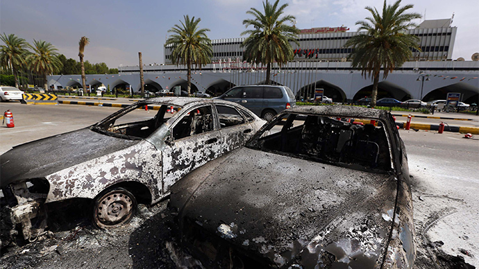 Burnt vehicles are seen in the compound of Tripoli international airport in the Libyan capital on July 14, 2014 following fighting between rival armed groups (AFP Photo / Mahmud Turkia)