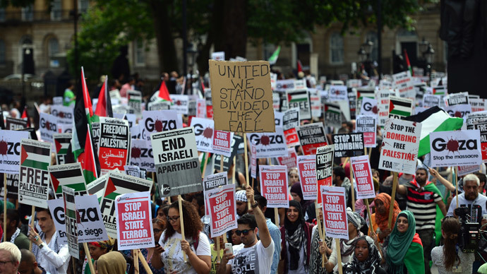 Protesters display placards and banners as they take part in demonstration against Israeli airstrikes in Gaza in central London on July 19, 2014.(AFP Photo / Carl Court)