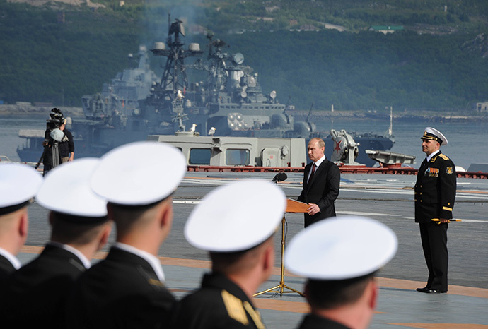 Russian President Vladimir Putin, 2nd right, is seen on board the Admiral Kuznetsov aircraft carrier congratulating mariners before the parade and the staged performance by combat ships of Russia's Northern Fleet, July 27, 2014. (RIA Novosti / Michael Klimentyev)