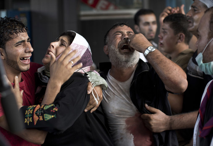 Palestinian mourners cry at Gaza City's al-Shifa hospital after an explosion killed at least seven children in a public playground in the beachfront Shati refugee camp on July 28, 2014. (AFP Photo/Mahmud Hams)