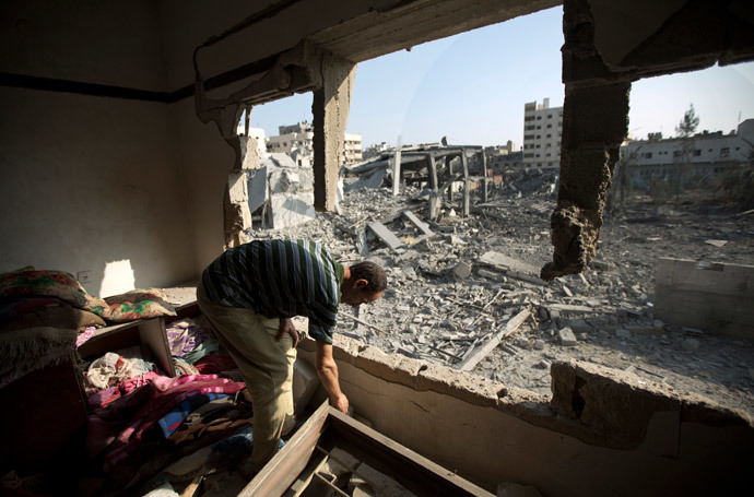 A Palestinian man inspects a destroyed home on August 2, 2014 following an overnight Israeli strike on Gaza City.(AFP Photo / Mahmud Hams)