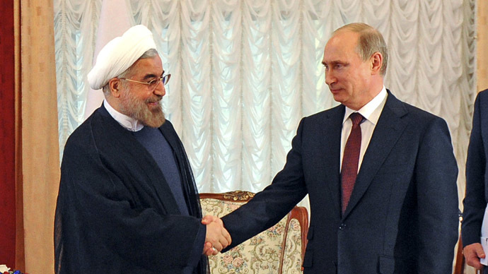 Russia's President Vladimir Putin (2nd L) shakes hands with his Iranian counterpart Hassan Rouhani (L) (Reuters/Mikhail Klimentyev)