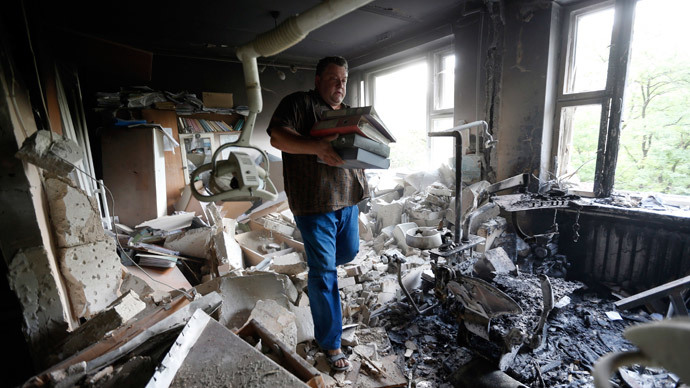 A man inspects wreckage inside a damaged building following what locals say was shelling by Ukrainian forces in Donetsk August 7, 2014.(Reuters / Sergei Karpukhin )