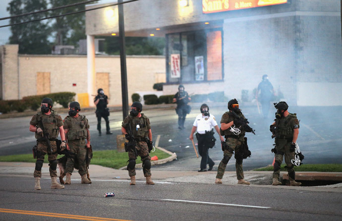 Tear gas hangs in the air as police force protestors from the business district into nearby neighborhoods on August 11, 2014 in Ferguson, Missouri. (Scott Olson / Getty Images / AFP) 