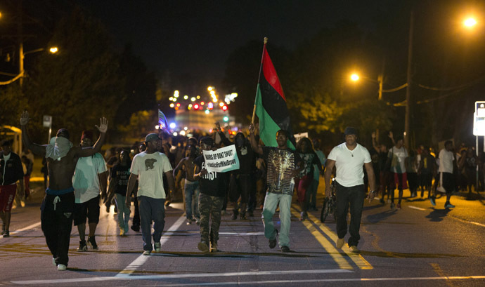 Demonstrators march in the street while protesting the shooting death of black teenager Michael Brown in Ferguson, Missouri August 12, 2014. (Reuters)
