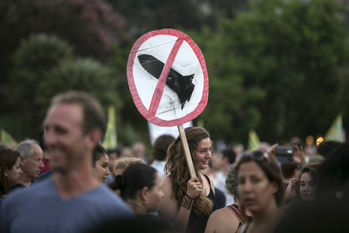 A girl holds a sign during a rally in Tel Aviv's Rabin Square, to show solidarity with residents of Israel's southern communities, who have been targeted by Palestinian rockets and mortar salvoes, August 14, 2014. (Reuters / Baz Ratner)