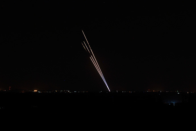 Light trails made by rockets fired from the Gaza Strip mark the night sky from the Israel Gaza Border on August 19,2014. (AFP Photo / David Buimovitch)