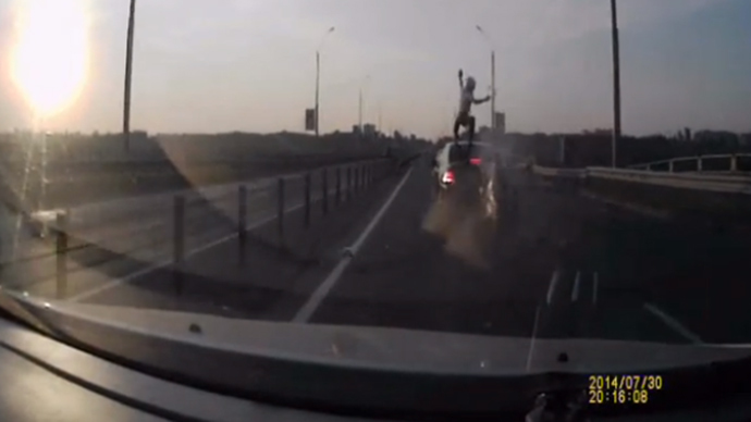 ​Biker survives rear-ending car by vaulting on to its roof (VIDEO)