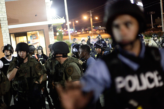 Police in riot gear detain a demonstrator (C) protesting against the shooting of Michael Brown, in Ferguson, Missouri August 19, 2014 (Reuters / Joshua Lott)