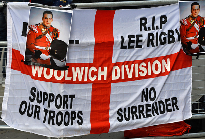 A banner and photographs of murdered soldier Lee Rigby are displayed during a protest outside the Old Bailey courthouse in London February 26, 2014 (Reuters / Toby Melville)