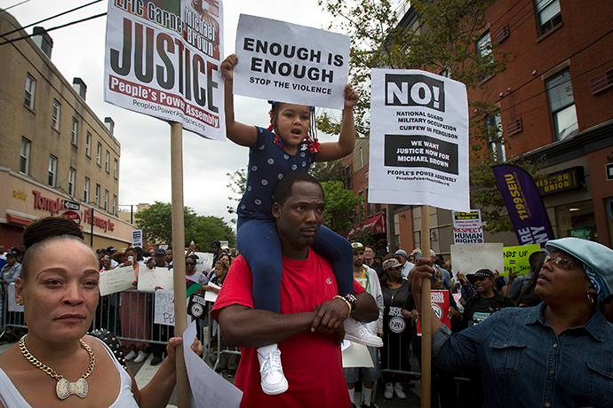 People take part in the "We Will Not Go Back" march and rally for Eric Garner in the Staten Island borough of New York August 23, 2014 (Reuters / Carlo Allegri)