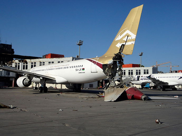 A damaged aircraft is pictured after shelling at Tripoli International Airport August 24, 2014 (Reuters / Aimen Elsahli)