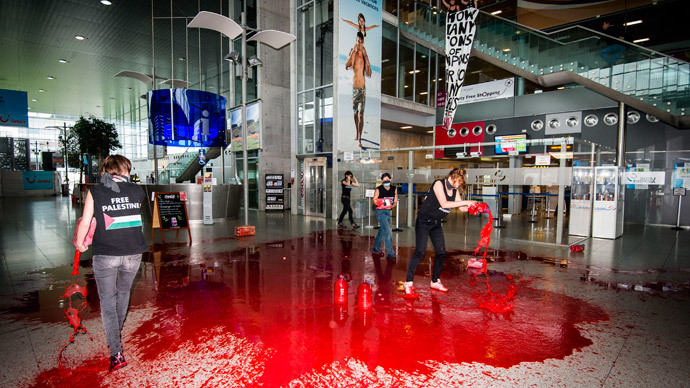 ‘No weapons for Israel!’ Protest group pours fake blood in Belgium airport