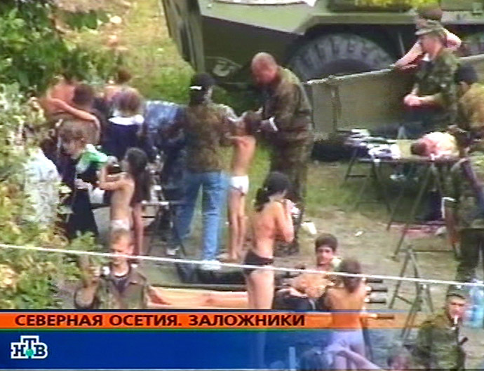 This TV-grab image taken from Russian channel NTV shows hostages in the school garden during the rescue operation 03 September 2004 in the town of Beslan, North Ossetia. (AFP/NTV)