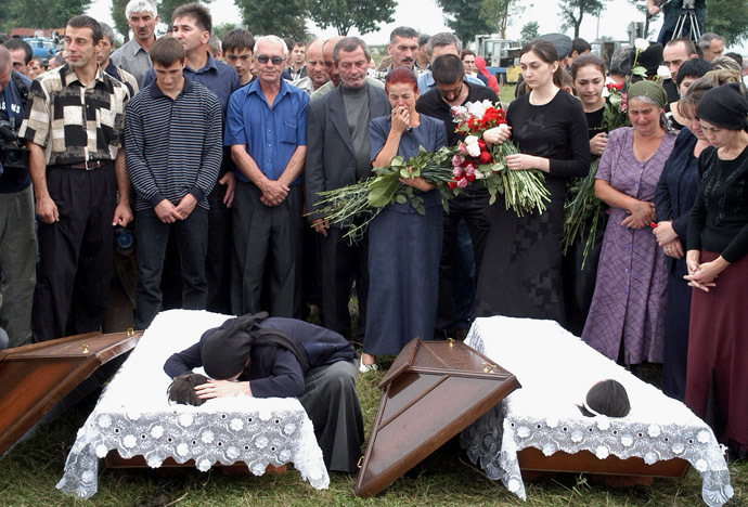 Fatima Tetova, mother of killed hostages Irina,13 and Alina,12, cry during their funeral in the town of Beslan in the province of North Ossetia near Chechnya , September 5, 2004. (Reuters)