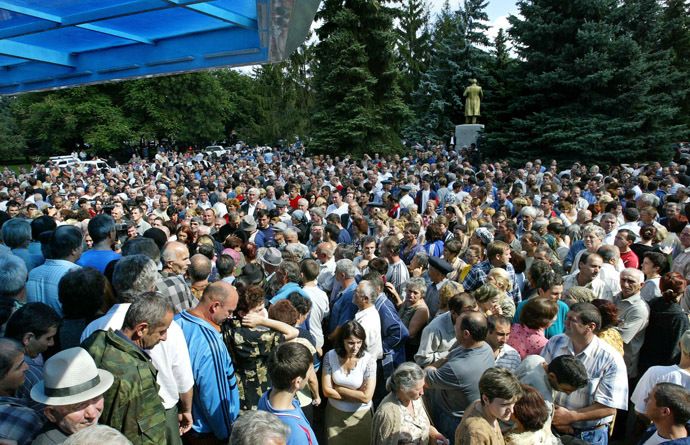Hundreds of Ossetian inhabitants, relatives of hostages wait outside the school, where a group of gunmen, wearing belts laden with explosives, are holding hostage some 350 people in the northern Ossetian town of Beslan, some 30 kms outside Vladikavkaz, 02 September 2004. (AFP Photo/Maxim Marmur)