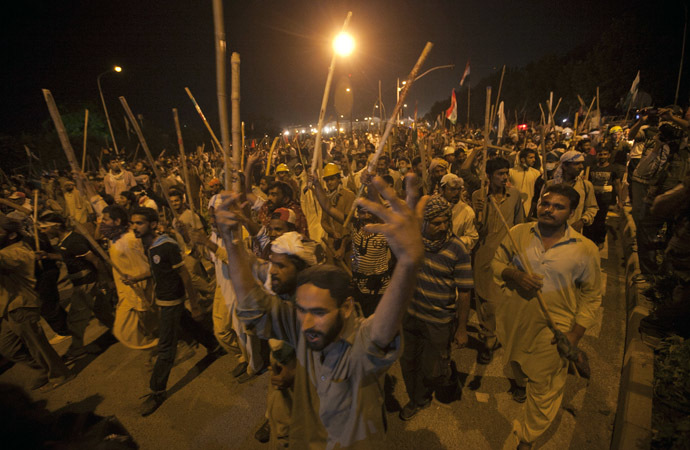 Supporters of Tahir ul-Qadri, Sufi cleric and leader of political party Pakistan Awami Tehreek (PAT), carry sticks as they move towards the Prime Minister's house during the Revolution March in Islamabad August 30, 2014. (Reuters/Akhtar Soomro)