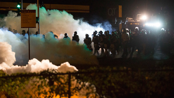 Riot police clear a street with smoke bombs while clashing with demonstrators in Ferguson, Missouri August 13, 2014.(Reuters / Mario Anzuoni)