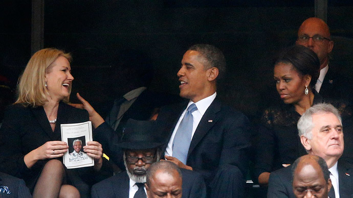 U.S. President Barack Obama (C) shares a moment with Denmark's Prime Minister Helle Thorning-Schmidt (L) as his wife, first lady Michelle Obama looks on (R) during the memorial service for late South African President Nelson Mandela at the First National Bank stadium, also known as Soccer City, in Johannesburg December 10, 2013.(Reuters / Kai Pfaffenbach)