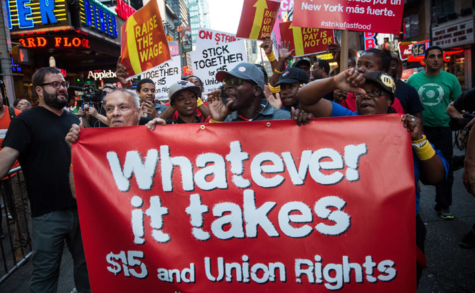 Protesters demanding higher wages and unionization for fast food workers march near Times Square on September 4, 2014 in New York City.(AFP Photo / Andrew Burton)
