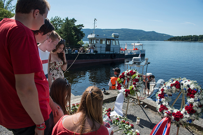Members of AUF, the Labour Party Youth Organization, attend a wreath laying ceremony to mark the second year anniversary of the twin Oslo-Utoya massacre by self confessed killer Anders Breivik in Utvika July 22, 2013 (Reuters / Aleksander Andersen)