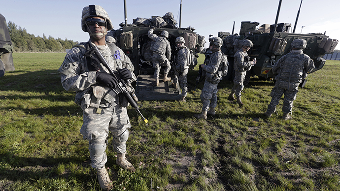 U.S. second cavalry regiment soldiers stand with armoured personal carriers during the "Steadfast Javelin II" military exercise in the Lielvarde air base, September 6, 2014. (Reuters / Ints Kalnins)